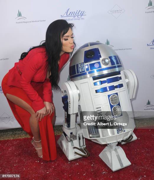 Model CJ Sparxx poses with R2D2 at A Children's Miracle Holiday Sponsored by Amity Medical Group and Vitamin Patch Club in Partnership with Foothill...