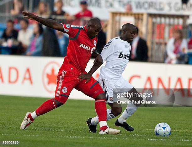 Forward Ali Gerba of the Toronto FC collides with midfielder Lassana Diarra of Real Madrid during the match at BMO Field on August 7, 2009 in...