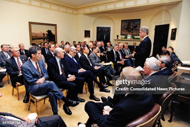 American politician US President Bill Clinton consults with a bipartisan group of Congressional leadership in the White House's Roosevelt Room,...