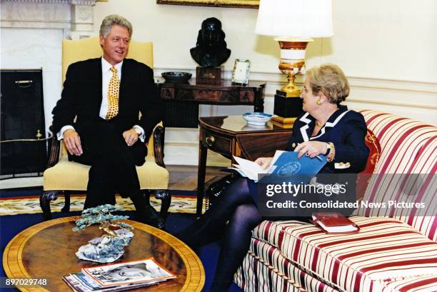 President Bill Clinton and Secretary of State Madeleine Albright talk together in the White House's Oval Office, Washington DC, September 8, 1997.