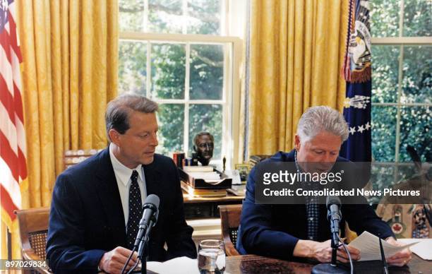 Vice President Al Gore watches US President Bill Clinton as they jointly deliver a radio address from White House's Oval Office, Washington DC,...