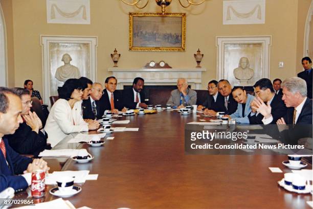American politician US President Bill Clinton meets with members of the Congressional Hispanic Caucus in the White House's Cabinet Room, Washington...