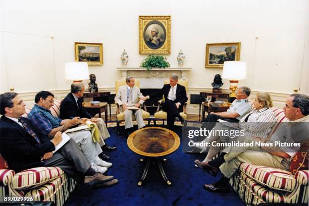 American politician US President Bill Clinton meets with advisors in the White House's Oval Office, Washington DC, July 22, 1995. Pictured are, from...