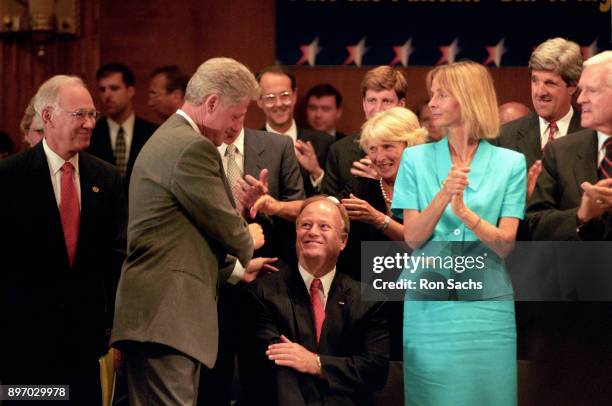 American politician US President Bill Clinton greets US Senator Max Cleland at an event in the Dirksen Senate Office Building on Capitol Hill,...