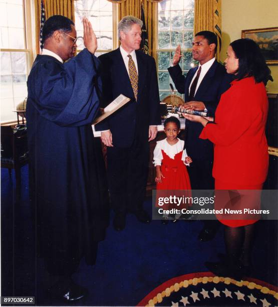 American politician US President Bill Clinton witnesses as Judge Curtis Collier officiates the swearing-in ceremony of US Secretary of Transportation...