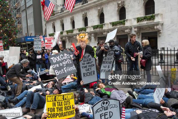 Protestors demonstrate against the 2017 tax bill about to be passed by a Republican congress on December 19, 2017 on Wall Street in New York City....