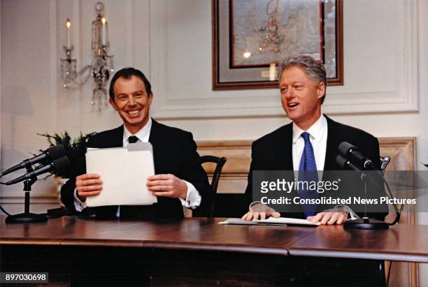 British Prime Minister Tony Blair and US President Bill Clinton share a laugh together as they deliver a joint radio address from the White House,...
