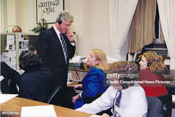 After delivering the State of the Union Address, American politician US President Bill Clinton speaks on the phone along with White House Comment...