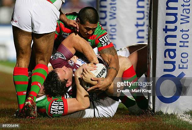 Josh Perry of the Sea Eagles is held up over the line during the round 22 NRL match between the Manly Warringah Sea Eagles and the South Sydney...