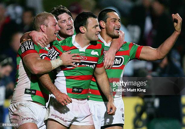 Beau Champion of the Rabbitohs celebrates with Michael Crocker, Chris McQueen and John Sutton after scoring the final try during the round 22 NRL...