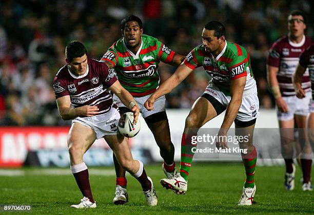 John Sutton of the Rabbitohs strips the ball from Ben Farrar of the Sea Eagles which leads to the try of Anthony Watmough during the round 22 NRL...