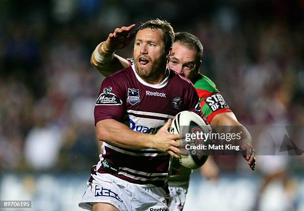 Matt Orford of the Sea Eagles is chased down by Luke Stuart of the Rabbitohs during the round 22 NRL match between the Manly Warringah Sea Eagles and...