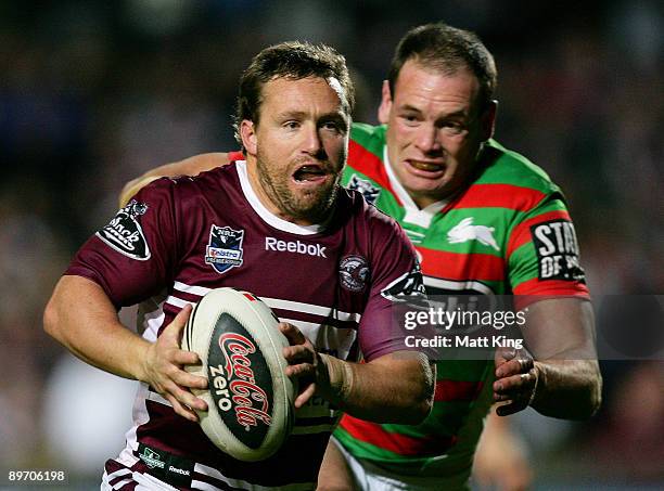 Matt Orford of the Sea Eagles is chased down by Luke Stuart of the Rabbitohs during the round 22 NRL match between the Manly Warringah Sea Eagles and...