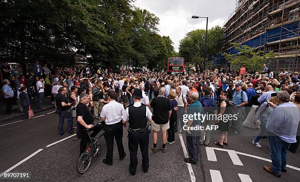 Fans and media fill Abbey Road on August 8, 2009 during an event to celebrate 40 years to the minute since the Abbey Road album cover photograph was...