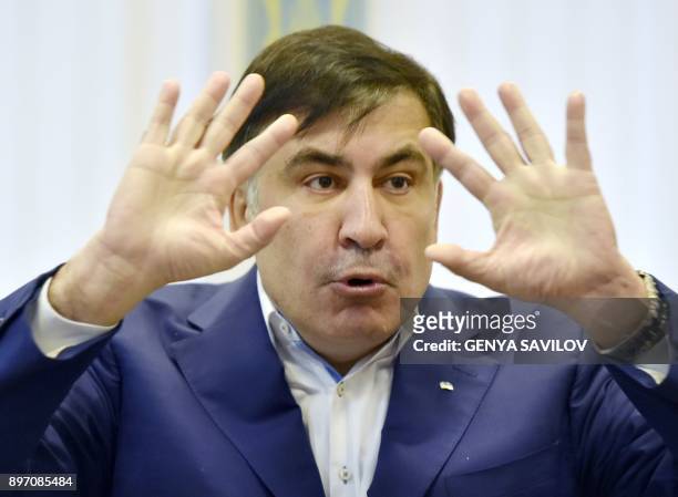 Former Georgian president Mikheil Saakashvili gestures as he speaks to the media after attending his appeal hearing at a courthouse in Kiev on...