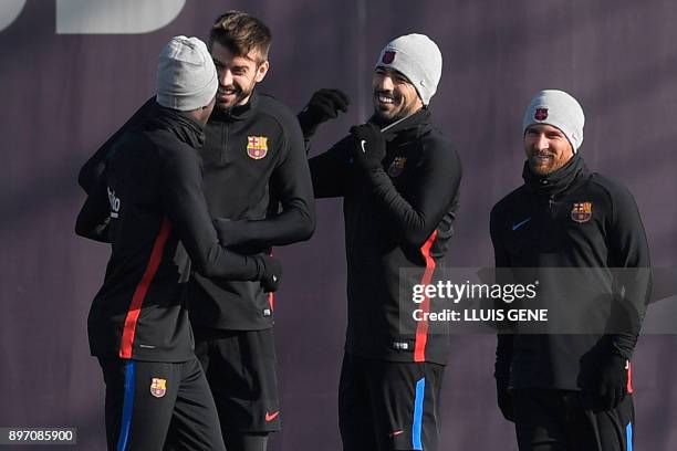 Barcelona's defender Gerard Pique , Barcelona's Uruguayan forward Luis Suarez and Barcelona's Argentinian forward Lionel Messi joke with Barcelona's...