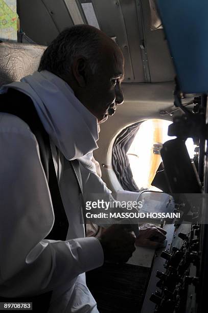 Afghan presidential candidate and former finance minister Ashraf Ghani drinks coffee during his trip on a military plane to the northern province...