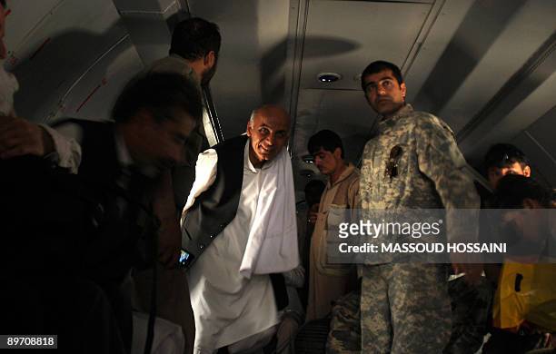 Afghan presidential candidate and former finance minister Ashraf Ghani disembarks from a military plane during his trip to the northern province...
