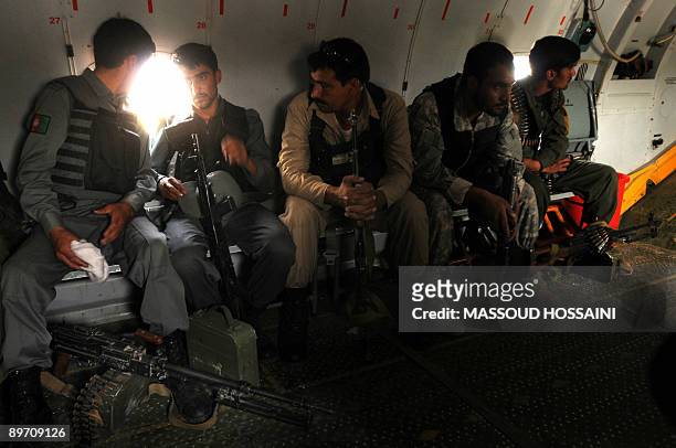 Afghan bodyguards of Afghan presidential candidate and former finance minister Ashraf Ghani sit on a military plane during a campaign trip to Maymana...