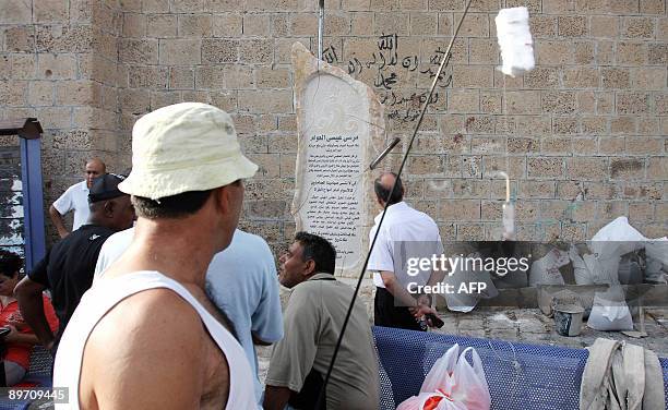 Passersby look at a monument erected in memory of Issa al-Awam, who fought alongside warrior Salaheddine al-Ayyubi in 1189 AD, in the Arab Israeli...