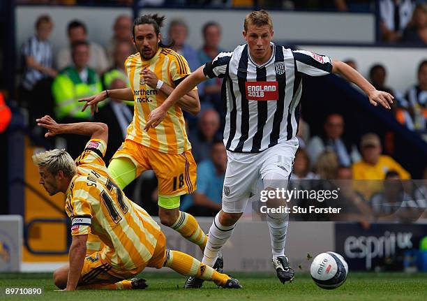 Newcastle captain Alan Smith is beaten to the ball by West Brom striker Chris Wood during the Coca Cola Championship game between West Bromwich...