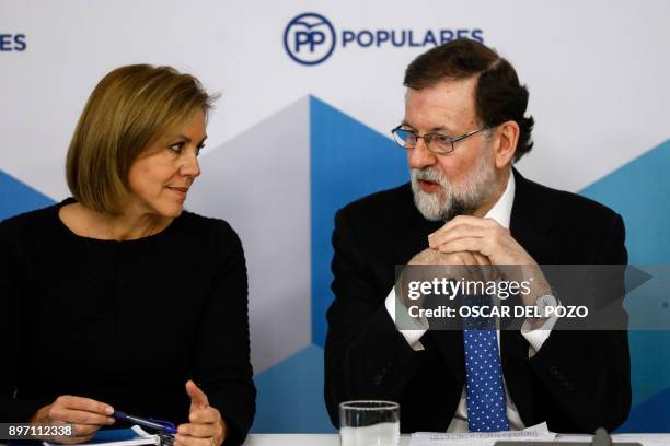 Spanish Prime Minister Mariano Rajoy and her Spanish Minister of Defence Maria Doroles de Cospedal attend a Popular Party meeting of the national...