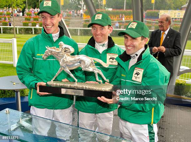 Jocckeys Richard Hughes, Neil Callan and Seamus Heffernan of Team Ireland pose with their winner trophy at The Dubai Duty Free Shergar Cup at Ascot...