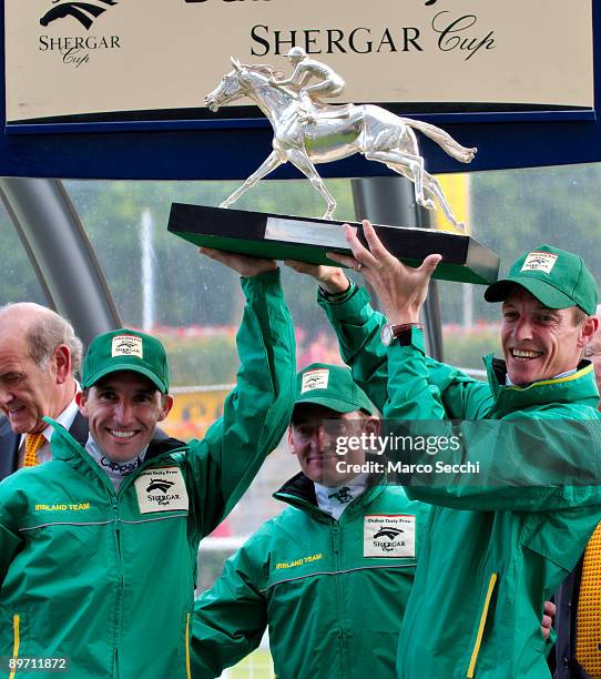 Jocckeys Richard Hughes, Neil Callan and Seamus Heffernan of Team Ireland pose with their winner trophy at The Dubai Duty Free Shergar Cup at Ascot...