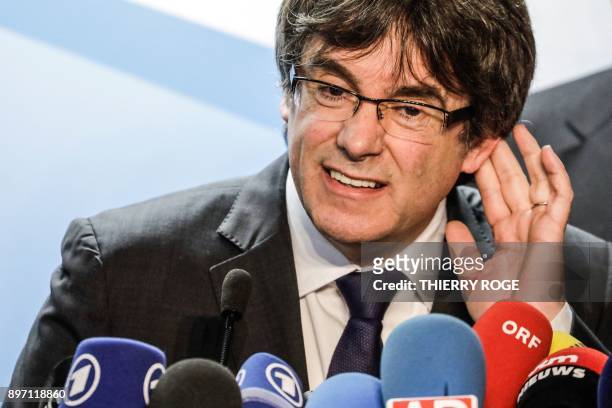 Axed Catalan president Carles Puigdemont gestures during a press conference on December 22, 2017 in Brussels, a day after the Catalonia's regional...