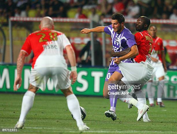 Monaco's defender Cedric Mongongu vies with Toulouse's forward Andre-Pierre Gignac during their French L1 football match Monaco vs. Toulouse, on...