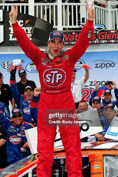 Marcos Ambrose, driver of the STP Toyota, celebrates in victory lane after winning the NASCAR Nationwide Series Zippo 200 at Watkins Glen...