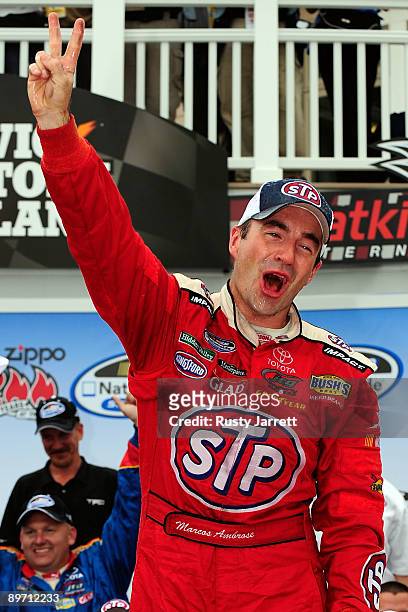Marcos Ambrose, driver of the STP Toyota, celebrates in victory lane after winning the NASCAR Nationwide Series Zippo 200 at Watkins Glen...