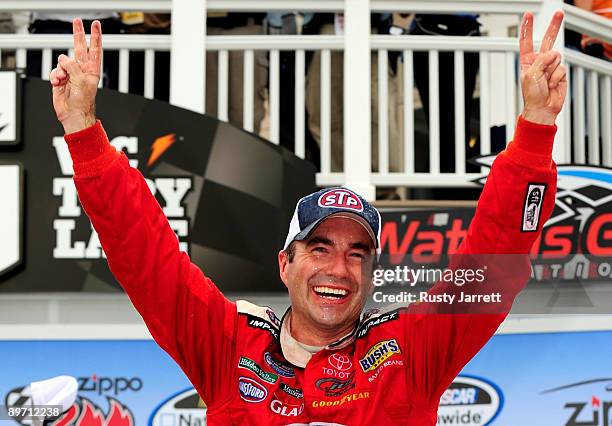 Marcos Ambrose, driver of the STP Toyota, celebrates in victory lane after winning the NASCAR Nationwide Series Zippo 200 at Watkins Glen...