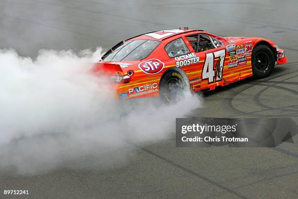 Marcos Ambrose, driver of the STP Toyota, celebrates after winning the NASCAR Nationwide Series Zippo 200 at Watkins Glen International on August 8,...