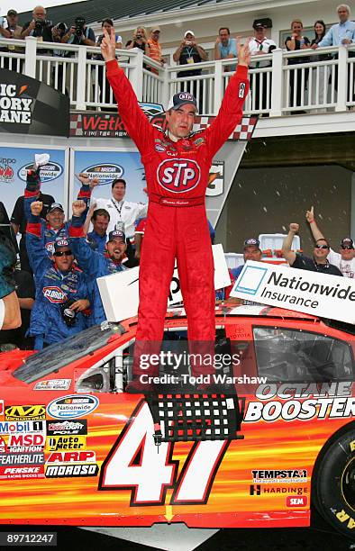 Marcos Ambrose, driver of the STP Toyota, celebrates in victory lane after winning the NASCAR Nationwide Series Zippo 200 at Watkins Glen...