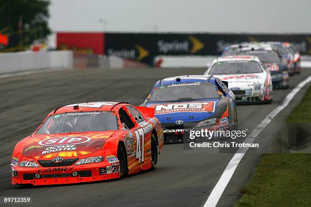 Marcos Ambrose, driver of the STP Toyota, leads Kyle Busch, driver of the NOS Toyota and Carl Edwards, driver of the Save a Lot Ford, during the...