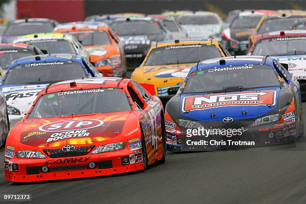 Marcos Ambrose, driver of the STP Toyota, leads the field during the NASCAR Nationwide Series Zippo 200 at Watkins Glen International on August 8,...