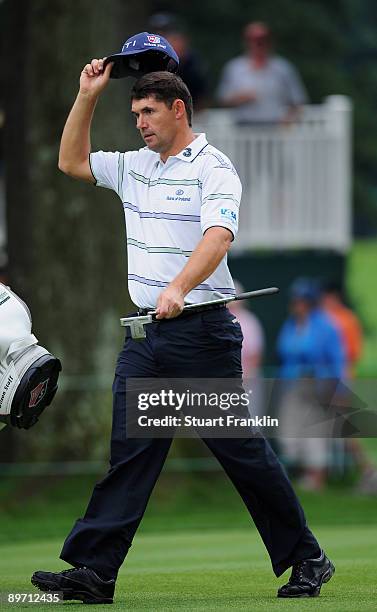 Padraig Harrington of Ireland doffs his cap on the 18th hole during the third round of the World Golf Championship Bridgestone Invitational on August...