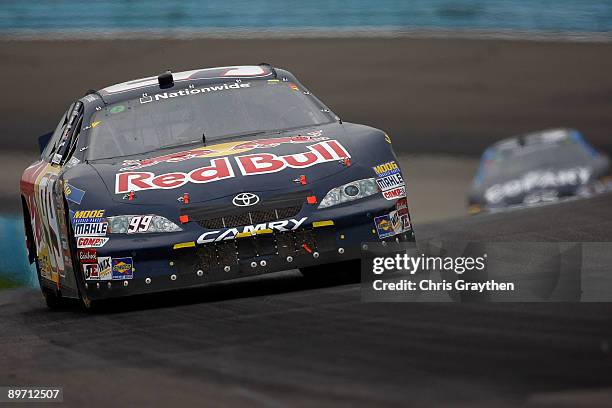 Scott Speed, driver of the Red Bull Toyota, leads a group of cars during the NASCAR Nationwide Series Zippo 200 at Watkins Glen International on...