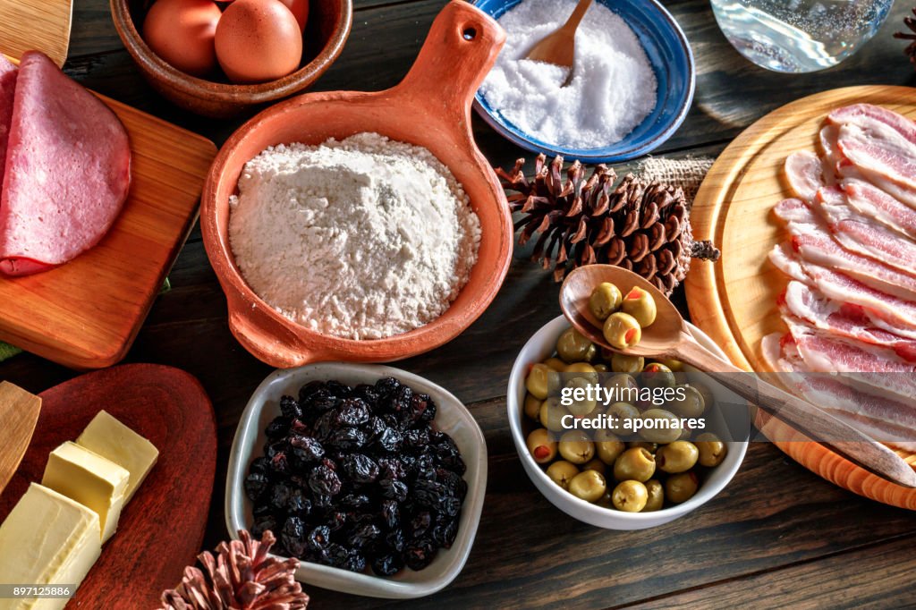 Christmas food Venezuelan cuisine ingredients for jam bread or pan de jamon over wooden table