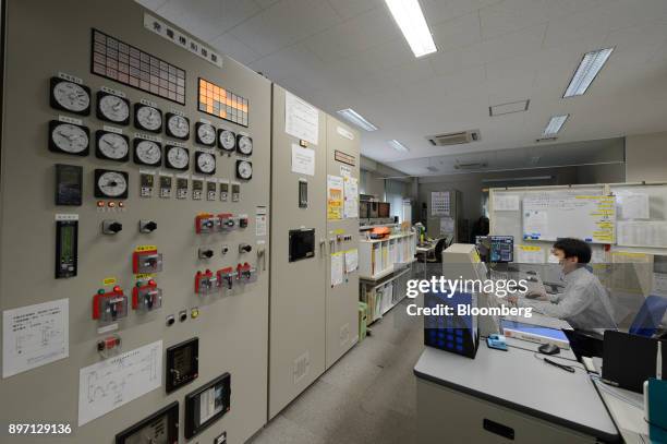 An employee works in a control room at the Gonoike Biomass Power Station, operated by Gonoike Bioenergy Corp., a subsidiary of Mitsubishi Corp., in...