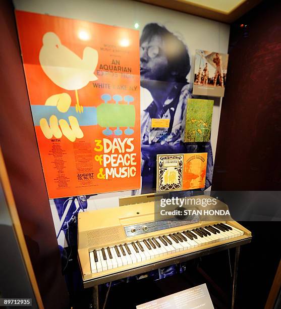 An original promotional poster designed by Arnold Skolnick and an electric piano used by Sha Na Na member Donny York are seen at the Woodstock Music...