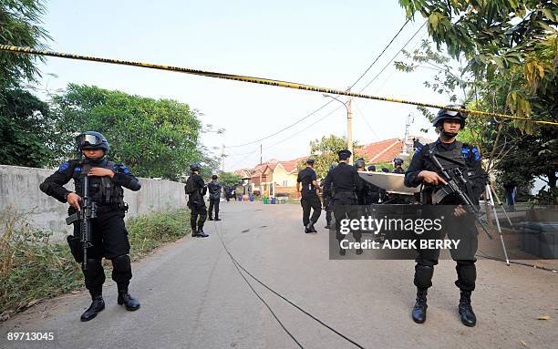 Indonesia-attacks-security,ANALYSIS by Stephen Coates Indonesian anti-terror policemen stand guard near a suspected terrorist house in Bekasi near...