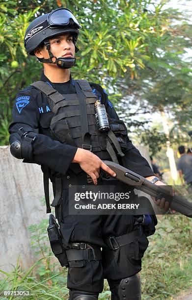 Indonesia-attacks-security,ANALYSIS by Stephen Coates An Indonesian anti-terror policeman stands guard near a suspected terrorist house in Bekasi...