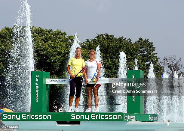 Elena Dementieva of Russia and Kim Clijsters of Belgium pose before a match on top of a Fountain at Kings Island before the start of the Wester &...