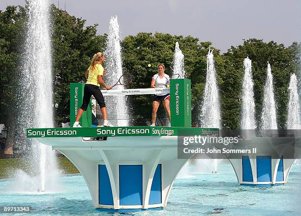 Elena Dementieva of Russia and Kim Clijsters of Belgium play a match on top of a Fountain at Kings Island before the start of the Wester & Southern...
