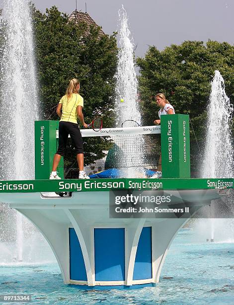 Elena Dementieva of Russia and Kim Clijsters of Belgium play a match on top of a Fountain at Kings Island before the start of the Wester & Southern...