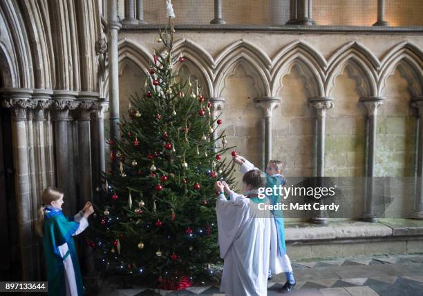 Choristers from the Salisbury Cathedral Choir decorate a Christmas tree ahead of their final practice ahead of the services that will be held in the...