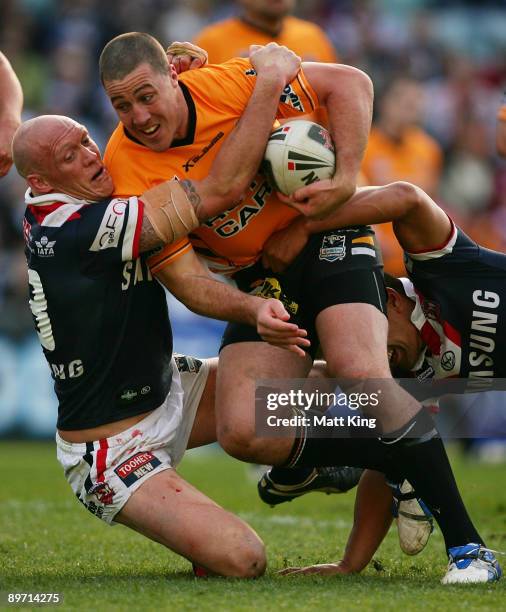 Bryce Gibbs of the Tigers is tackled by Craig Fitzgibbon of the Roosters during the round 22 NRL match between the Sydney Roosters and the Wests...