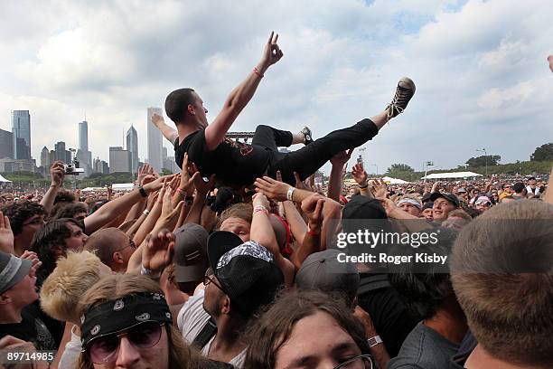 Festival-goer crowd surfs during the performance of Rise Against at the 2009 Lollapalooza music festival at Grant Park on August 8, 2009 in Chicago,...